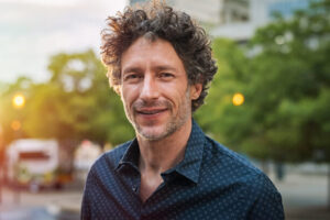 headshot of a man outside