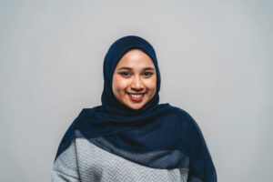 headshot of woman on gray background