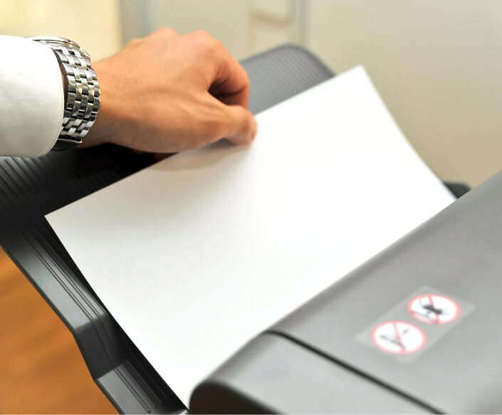 Hand grabbing paper from printer