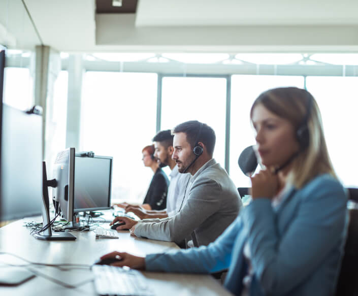 Group of people with headsets on the computer