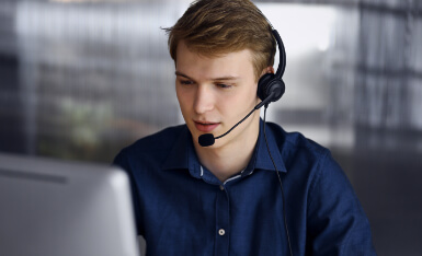 Man with headset on the computer