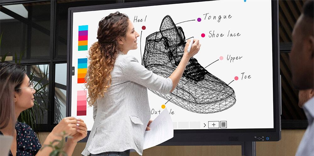 Woman writing on an interactive whiteboard