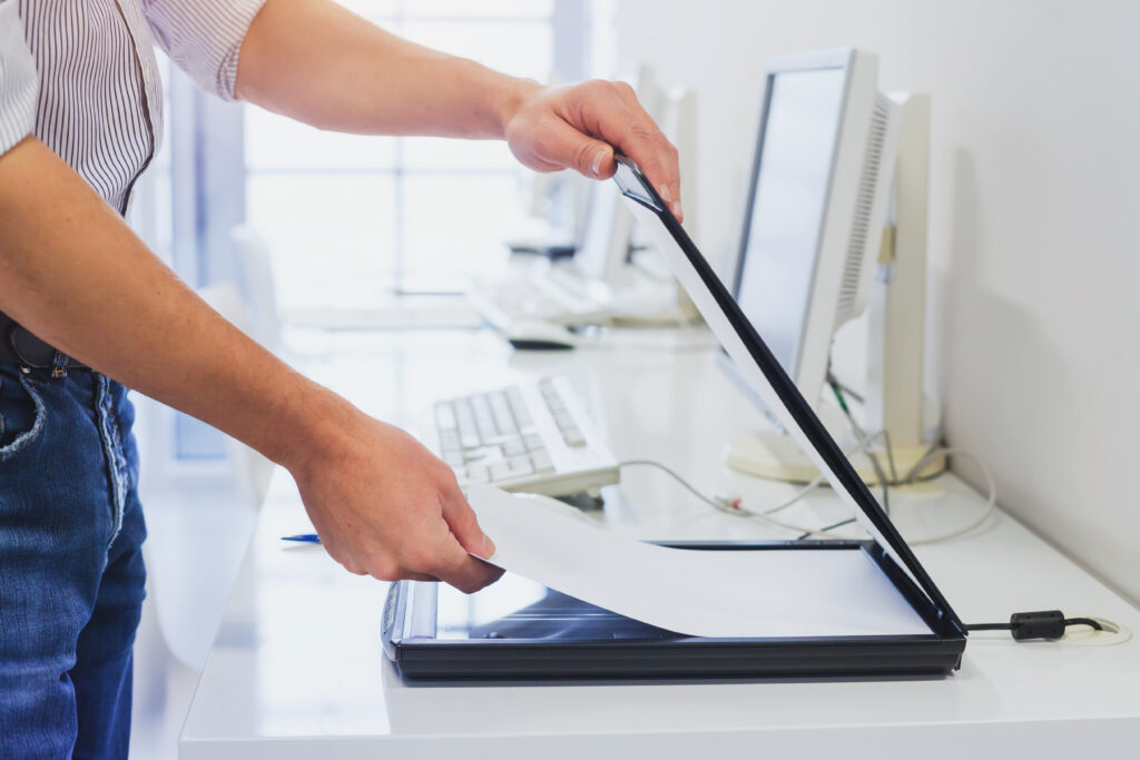 Close up of an office worker scanning documents using an office scanner