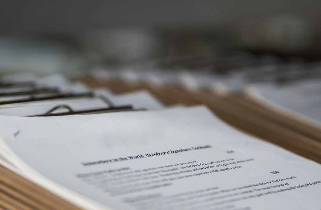 Stack of printed documents on a desk, shallow depth of field