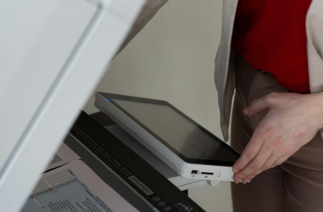 Person scanning a document on a multifunction printer