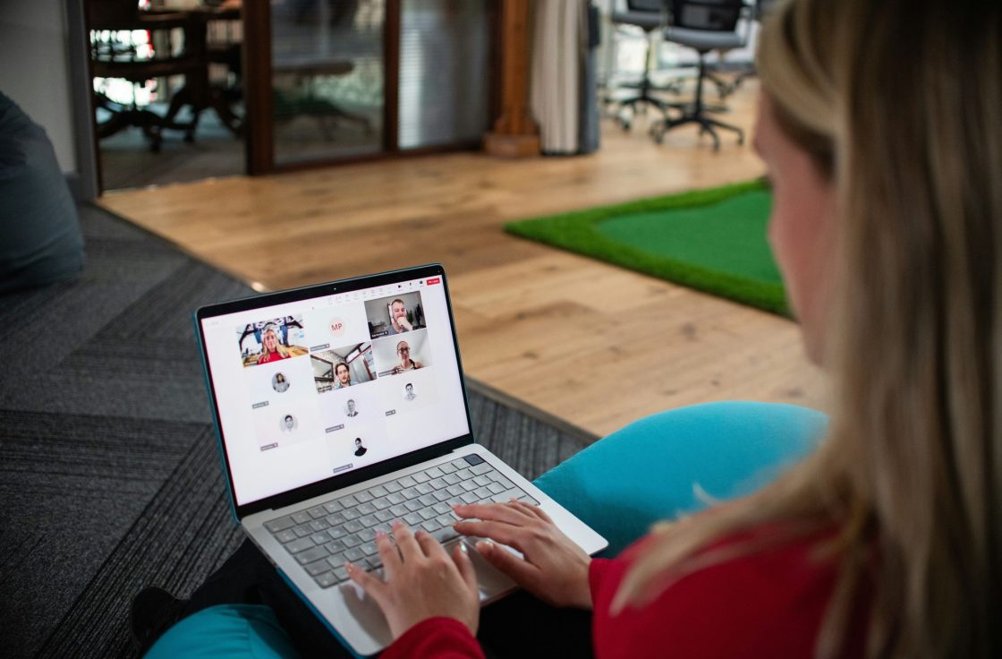 Person reading on a laptop in an office lounge
