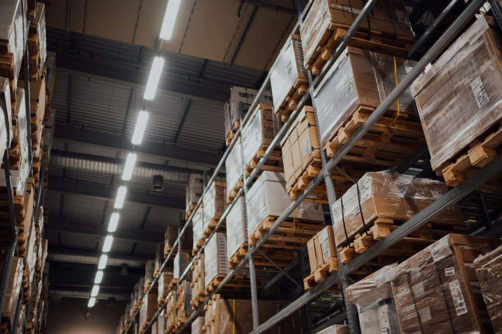 Warehouse aisle with shelves stacked with boxed freight
