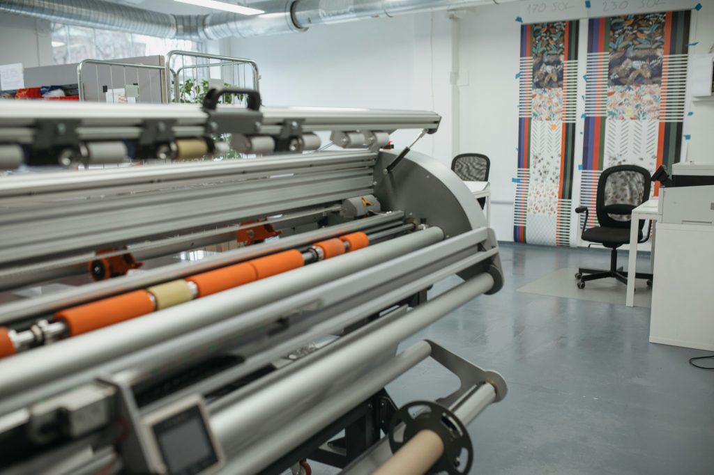 Wide-format printing and finishing equipment in a print shop