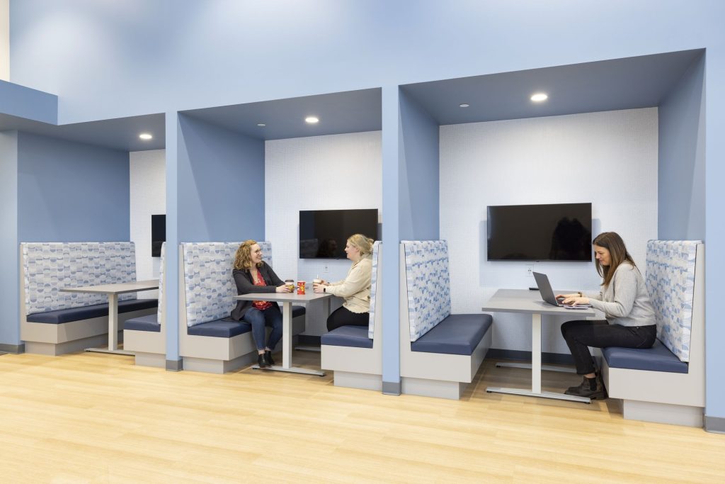 Metro Sales employees working in office meeting booths