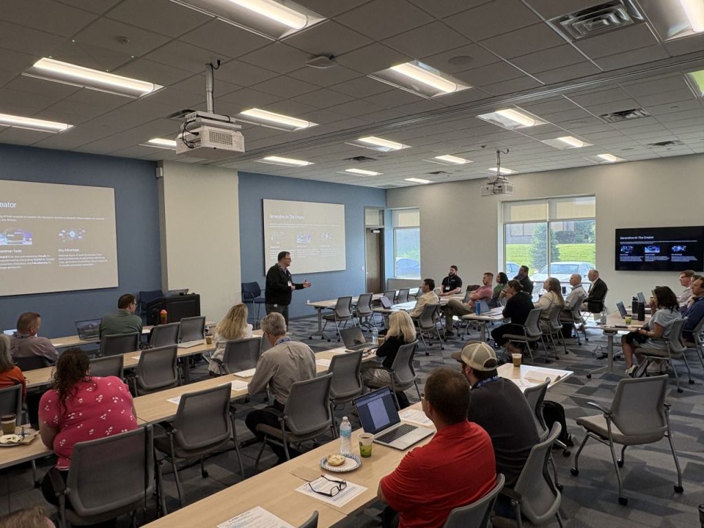 Room of professionals at tables during an AI workshop presentation