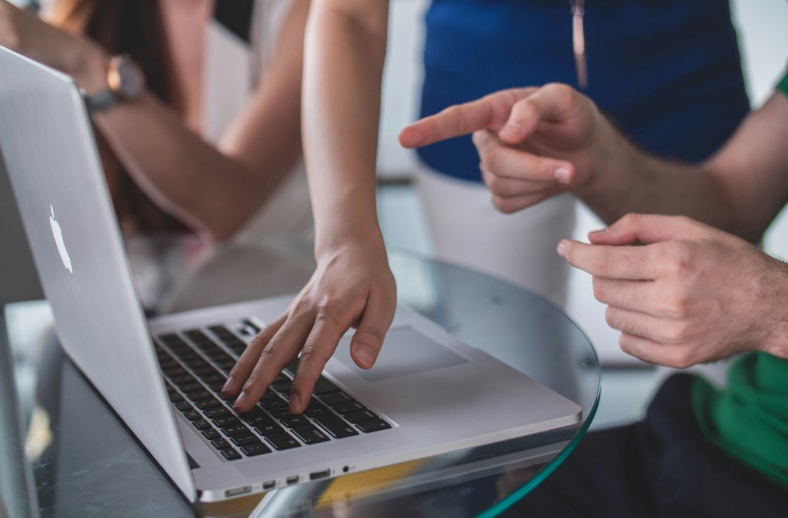 Colleagues pointing at a laptop during a document review