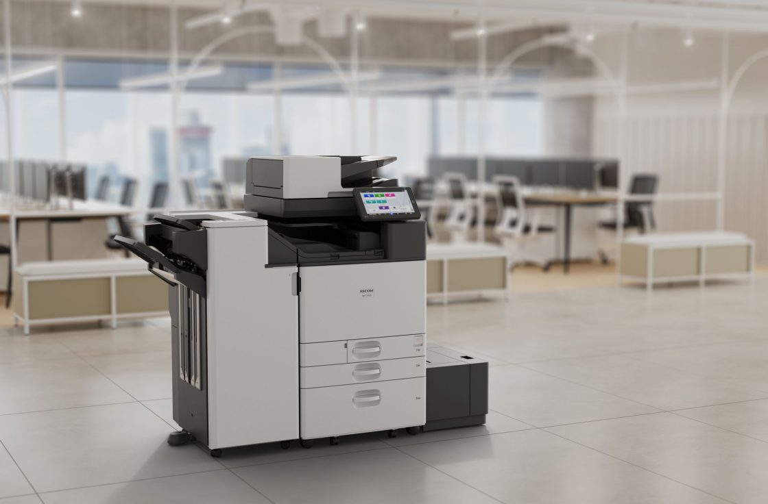 Ricoh IM C7010 printer with booklet finisher and large capacity tray in an office