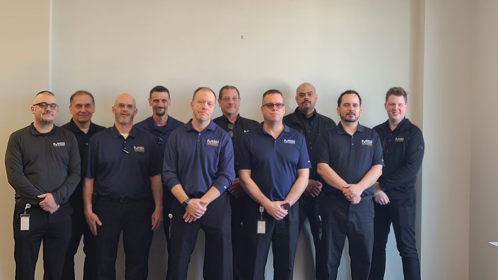 Metro Sales service technicians standing together in uniform
