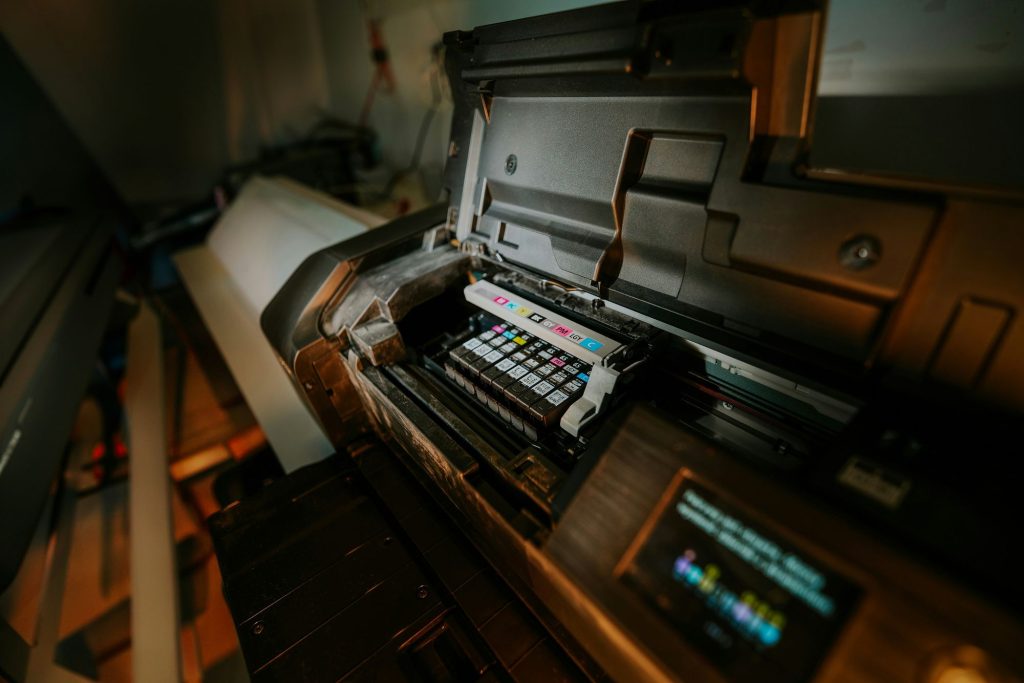Interior of a digital press with ink cartridges and control screen