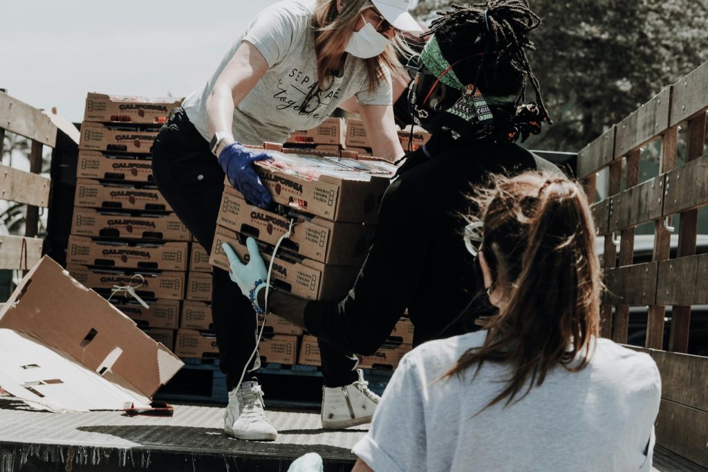 Volunteers unloading boxes of supplies from a truck