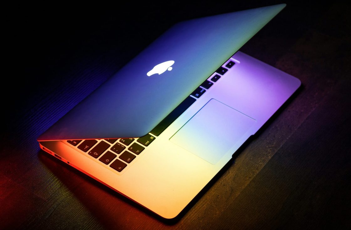 Open laptop glowing with colorful light